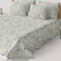Bedding set with green leaf pattern on a bed
